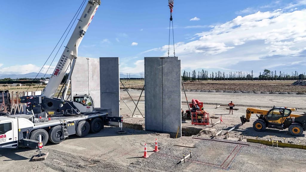 Precast vs Traditional Construction Cost Comparison (2026 Reliable Guide) 3 Precast concrete barrier load testing and quality control at a Canadian precast manufacturing yard