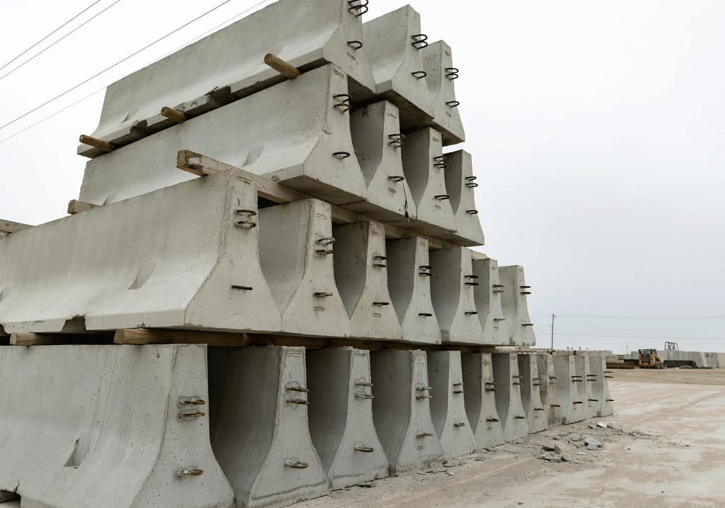 Precast Concrete Suppliers in Calgary: How to Choose (2026 Reliable Guide) 2 Stacked precast concrete barriers and retaining wall units at a Calgary precast concrete yard