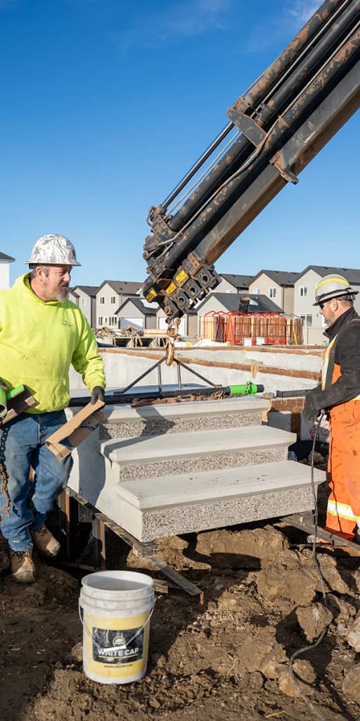 Precast Concrete Suppliers in Calgary: How to Choose (2026 Reliable Guide) 3 Precast concrete stair installation using crane on a residential construction site in Calgary